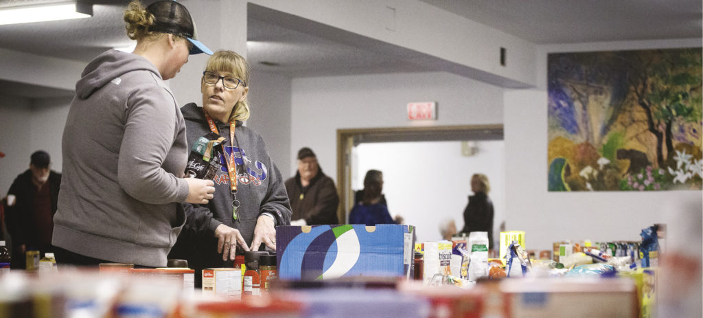 Carol Keber coordinates the volunteers sorting food at New Life Assembly. 